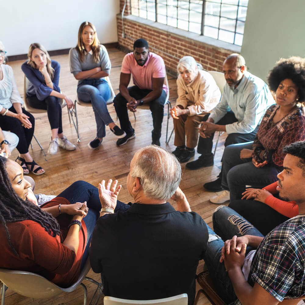 A group therapy session where members are engaged with one another's conversation